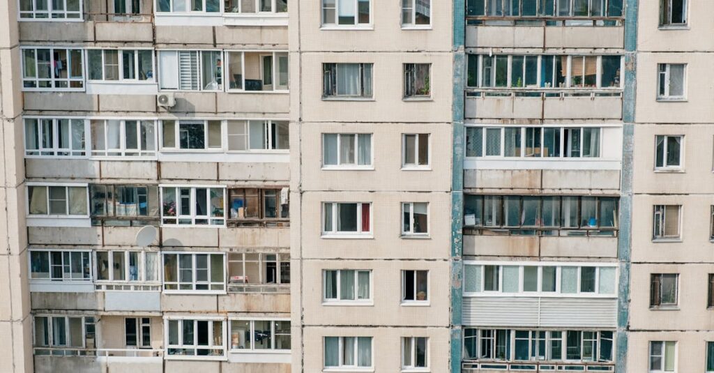 pexels-photo-4874580-4874580 Close-up view of a residential building facade with multiple windows captured during the day.